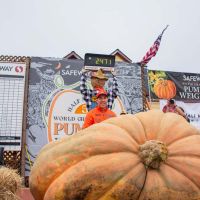 Winner Travis Gienger and his 2471 lb champion pumpkin